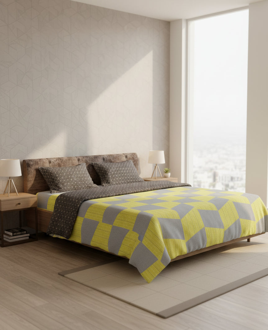 Bedroom with a bed featuring a yellow and gray checkered blanket.
