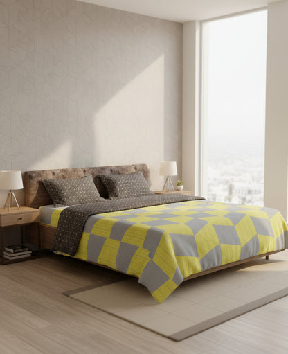 Bedroom with a bed featuring a yellow and gray checkered blanket.